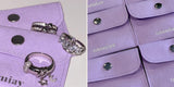 Oomiay sterling silver rings resting on lilac micro suede pouches