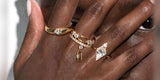 Hand with Oomiay rings held over a face