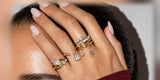 Woman wearing Oomiay rings, hand raised to her face