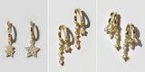 Three gold earrings side by side: Stellar huggies, Prism double hoops and Vesper dangles