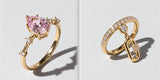 Nutcracker ring with a pink crystal in prongs beside the Broadway ring with a pavé band and charm