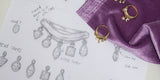 The original Spell ring sketch beside the finished gold Spell ring