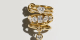 Stack of Oomiay gold rings with crystal charms