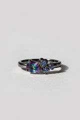 Dove Black Gold Ring with a mystic topaz pear, bezel-set heart, and two round stones