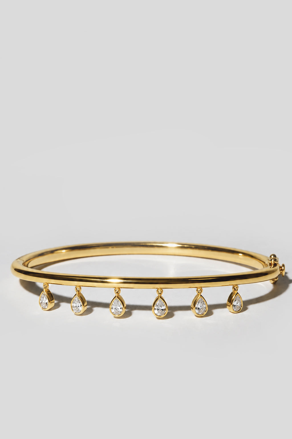 Gold Dangle Bangle. Hinged bangle with six dangling 4x6mm bezel pear crystals