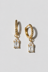 Gold Emerald Cut Huggies. Beaded huggie with a 5x7mm emerald cut white crystal charm under a three-crystal cap