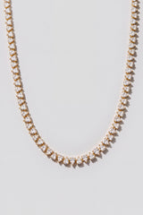 Gold Reverse Pear Cut Tennis Necklace. Hand-linked tennis necklace of 5x7mm reverse pear cut white crystals, spaced with a gap between each stone so it lays flat