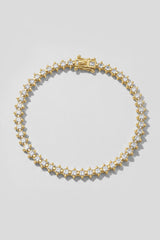 Gold Spike Tennis Bracelet. Hand-linked tennis bracelet of 2.5mm square crystals framed by spike accents