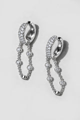 Silver Eclipse Earrings. Pavé huggie of mixed-size crystals with a draped bezel crystal chain