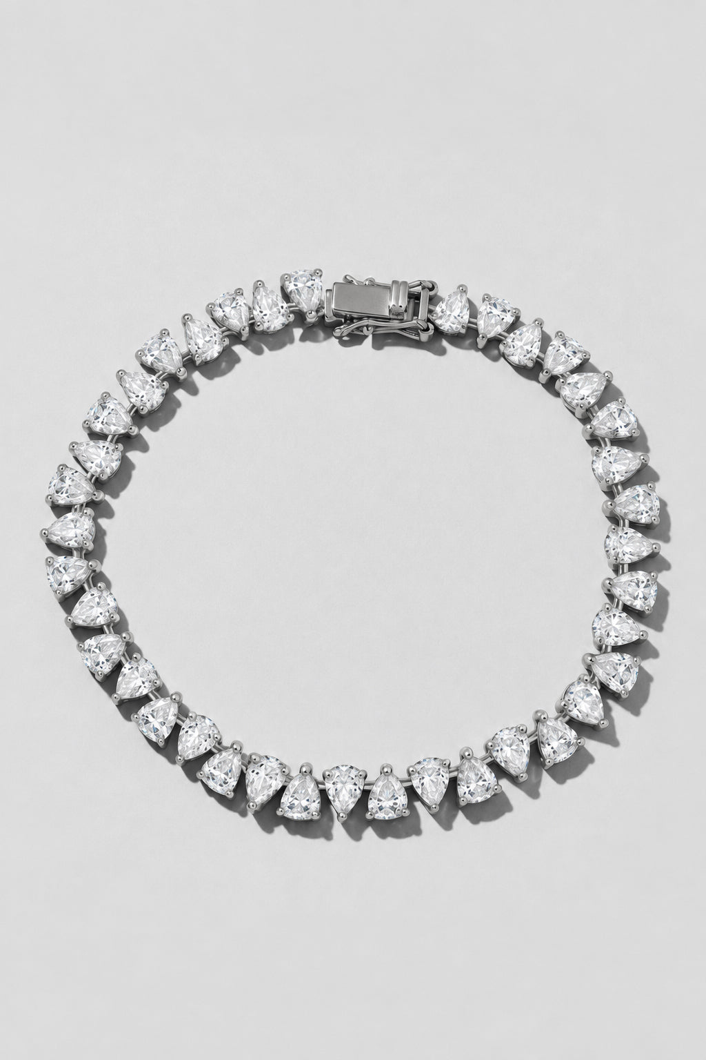 Silver Reverse Pear Cut Tennis Bracelet. Hand-linked tennis bracelet of 5x7mm reverse pear cut white crystals