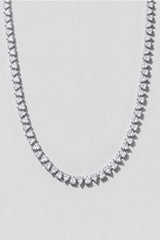 Silver Reverse Pear Cut Tennis Necklace. Hand-linked tennis necklace of 5x7mm reverse pear cut white crystals, spaced with a gap between each stone so it lays flat