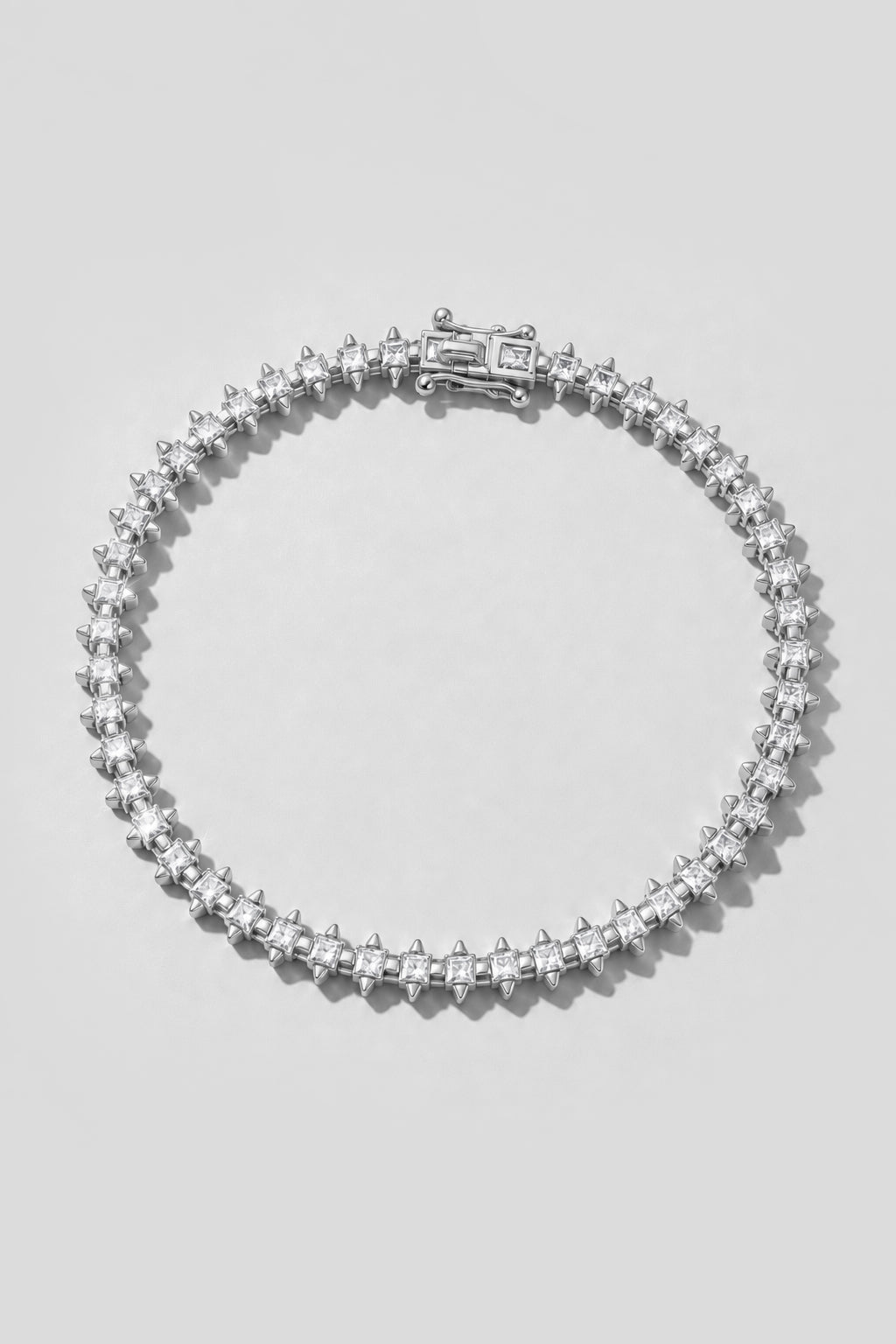 Silver Spike Tennis Bracelet. Hand-linked tennis bracelet of 2.5mm square crystals framed by spike accents